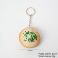 Shengjian bun food keychain with green onion and sesame details on a metal ring - PVC Pan-Fried Bun (Keychain Style)