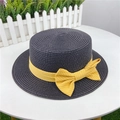 Detail of flat-top straw sun hat in dark grey with yellow striped bow on a table - M (56-58cm) Adjustable / Black