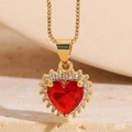 Macro shot of 14K gold plated heart pendant with red stone and zircon pavé detailing - Red Zirconia