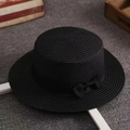 Detailed view of black straw boater hat with elegant woven texture and ribbon bow - M (56-58cm) / Black