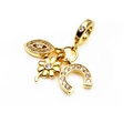 Macro detail of gold-plated lucky charms with clover, horseshoe and evil eye motifs - Lucky Evil Eye/Horseshoe
