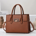 Detailed view of brown litchi pattern leather tote with golden twist lock and strap - Khaki/Earth Yellow