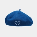 Close-up of heart embroidery detail on navy blue wool beret with soft felt texture - One Size / Cyan Blue
