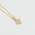 Minimalist gold necklace featuring a letter K pendant with unique textured scale finish - Letter K