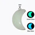 Luminous crescent moon crystal pendant with silver clasp showing green and blue glow effects - Luminous