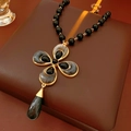 Detail of vintage flower and teardrop necklace with black beads and gold metallic frame - Necklace-Gold-Black