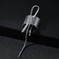 Close-up of silver metal ear cuff featuring bow design and long snake chain tassel - Silver (B8131)