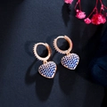 Sparkling rose gold heart hoop earrings with pavé blue zircons on black background - Blue