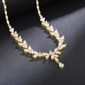 Macro shot of gold necklace featuring marquise and teardrop crystals in leaf design - Necklace / Gold Plated Necklace