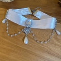 Macro view of white velvet choker with rhinestone snowflake and hanging pearls - White Velvet Snowflake Rhinestone Pendant Style