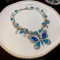 Close-up of hollow butterfly pendant necklace with blue crystals and heart charms - Butterfly Pendant Double Layer Necklace / Silver Blue (HN9093)