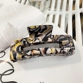 Large acetate hair claw clip with black white and yellow marble pattern and glossy finish - Black White Yellow Texture