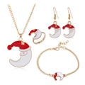 Macro shot of gold-plated Christmas jewelry set featuring Santa Moon enamel charms - Moon