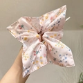 Pink floral silk scrunchie with cute rabbit and heart patterns held by hand - Pink Floral Satin Rabbit