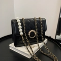 Detail of black quilted chain bag featuring large pearl pendant and golden hardware accents - Large / Black