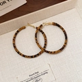 Retro leopard print hoop earrings with golden hooks on a beige minimalist tray - 925 Sterling Silver Earring Post Leopard Print Leather Wrap Hoop