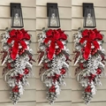 Flocked Christmas teardrop swag with red velvet bow, berries and pine cones on a wall - 45cm Red Flocked Upside Down Tree