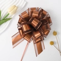 Close-up of bronze snow gauze pull bow ribbon for gift box decoration and floral packaging - Coffee