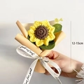 Close-up of a handmade knitted sunflower bouquet with beige wrapping and white ribbon - Mini Sunflower Puff