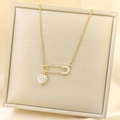 Golden safety pin necklace with heart pendant and pink gemstone on satin - Heart Safety Pin Pendant / Gold Pink