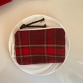 Detail of red and black tartan wool coin purse with a braided zipper pull and logo tag - Dark Red Large Grid