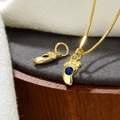 Nahaufnahme eines goldenen Fußanhängers mit blauem Zirkon für DIY-Schmuck - Blau