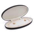 Oval black jewelry box with white pearl necklace and gold stud earrings set inside - Black