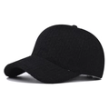 Close-up of thick black textured wool baseball cap with reinforced crown and curved brim - Adjustable / Black