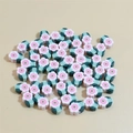 Close-up of handmade 10mm polymer clay flower beads for DIY jewelry and crafts - Pink