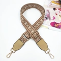 Close-up of geometric jacquard bag strap with leather ends and golden metal clips - Light Brown + Khaki Leather