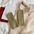 Olive green fingerless knit wool gloves with a small brown leather patch on beige wool coat - Straight-Mint Green