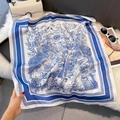 Detail of silk square scarf featuring blue and white landscape pattern on plush surface - 70*70cm / Blue Landscape Print