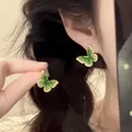 Close-up of green butterfly drop earrings with gold plating worn by a model - 3# Real Gold Plated Green Butterfly Earrings
