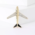 Golden airplane brooch with sparkling crystals and Love you more engraving on a white stand - Gold