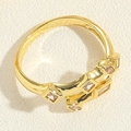 Detail of gold geometric ring with square and round zircon stone inlay on textured surface - Square Zirconia Ring