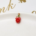Macro view of strawberry charm with red enamel oil drip finish and gold loop detail - 16# 3D Pink Strawberry