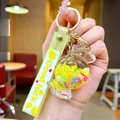 Close-up of yellow candy liquid keychain with glitter stars and Good Luck strap - Lollipop String [yellow] Glow-in-the-dark Bubble Bead Candy