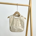 Waterproof baby bib in beige with brown floral pattern and front food catcher pocket - Sea Buckthorn Berry
