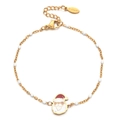 Macro detail of Christmas bracelet with enamel Santa charm and S.steel hallmark tag - White
