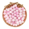 Macro detail of 10mm pink and white gradient cracked glass beads in a gold decorative tray - Jade-Like Pink White Lampwork Beads