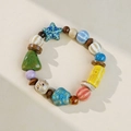 Ceramic beaded bracelet with colorful charms including a blue starfish and green tree bead - Blossom Starfish Style (1657-01) / Blue