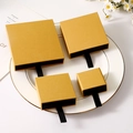 Elegant gold drawer jewelry boxes in four sizes displayed on a white ceramic plate - Champagne Gold + Black Inner Box