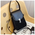 Chic black crossbody bag with silver metal lock on a modern yellow chair setting - Black