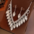 Dettaglio ravvicinato di orecchini e collana con goccia di cristallo su supporto in velluto - Set di 2 Pezzi Collana + Orecchini / Argento-Bianco