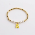 Bracciale elastico con perle e perline dorate con ciondolo a forma di orsetto giallo - Ciondolo Orso Smaltato / Giallo