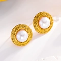 Detailed macro view of vintage gold stud earrings with white pearl and hammered texture - Stud Earrings / Gold