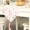 Linen Christmas table runner with red reindeer prints, scalloped edges and tassels - White Floral Print