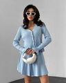Close-up of light blue knitted set with pearl buttons and pleated skirt details - S / Blue