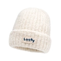 Winter chunky knit beanie in creamy white with Lucky patch made of cozy boucle yarn - Off White