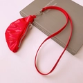 Detail of red faux leather croissant bag necklace with zipper and metallic finish - Red